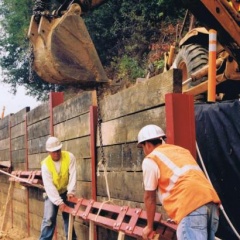 Steel I-beam wood logging wall construction in the Santa Cruz Mountains, CA.